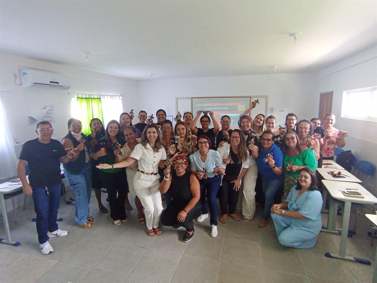 Grupo de professores de Caldas Brandão reunidos e comemorando em sala durante a formação continuada